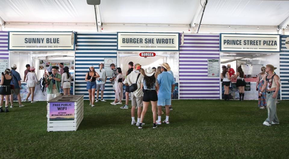 People get food at the Indio Central Market at the Coachella Valley Music and Arts Festival in Indio, Calif., April 12, 2024.