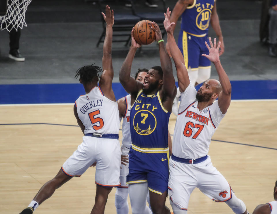 Golden State Warriors forward Eric Paschall (7) is defended by New York Knicks guard Immanuel Quickley (5) and center Taj Gibson (67) during the first half of an NBA basketball game Tuesday, Feb. 23, 2021, in New York. (Wendell Cruz/Pool Photo via AP)