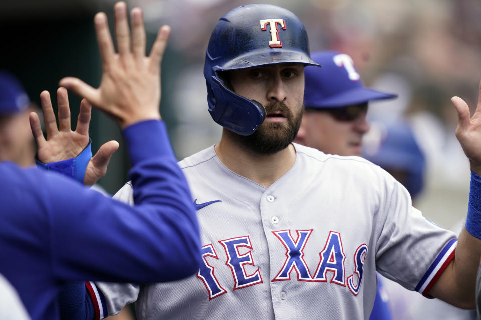 Texas Rangers designated hitter Joey Gallo is greeted in the dugout after scoring during the fourth inning of a baseball game against the Detroit Tigers, Thursday, July 22, 2021, in Detroit. (AP Photo/Carlos Osorio)