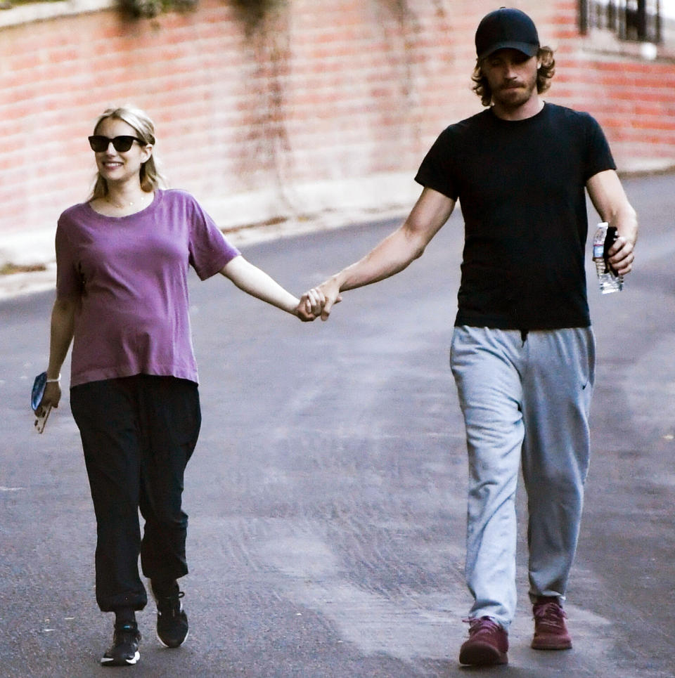 <p>Parents-to-be Emma Roberts and Garrett Hedlund hold hands as they go on a walk through L.A. on Sunday.</p>