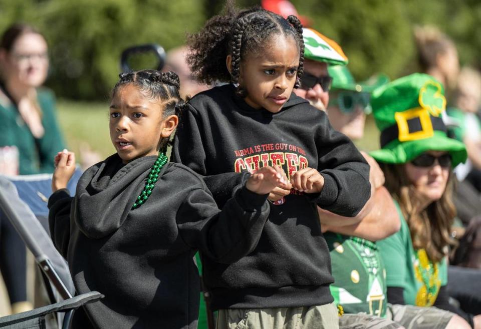 Sisters Kyra, 8, left, and Laycee Cook, 6, of Shawnee, danced as they watched the 38th annual Shawnee St. Patrick’s Day Parade on Sunday, March 10, 2024, in Shawnee.