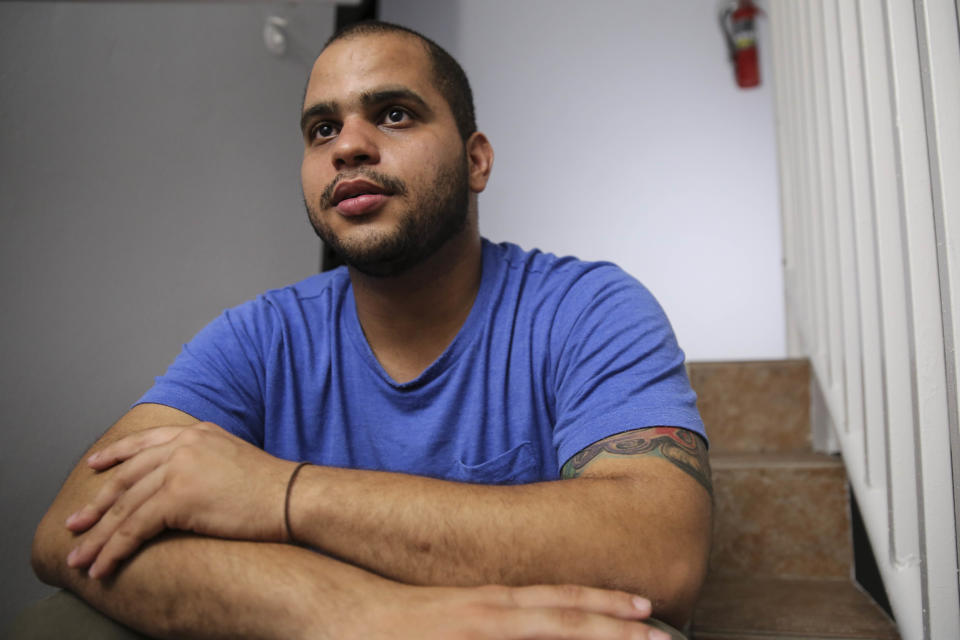 Christian Romero talks to HuffPost from the stairwell of his apartment complex on Oct. 14, 2017 in Carolina, Puerto Rico.&nbsp; (Photo: Carolina Moreno/HuffPost)