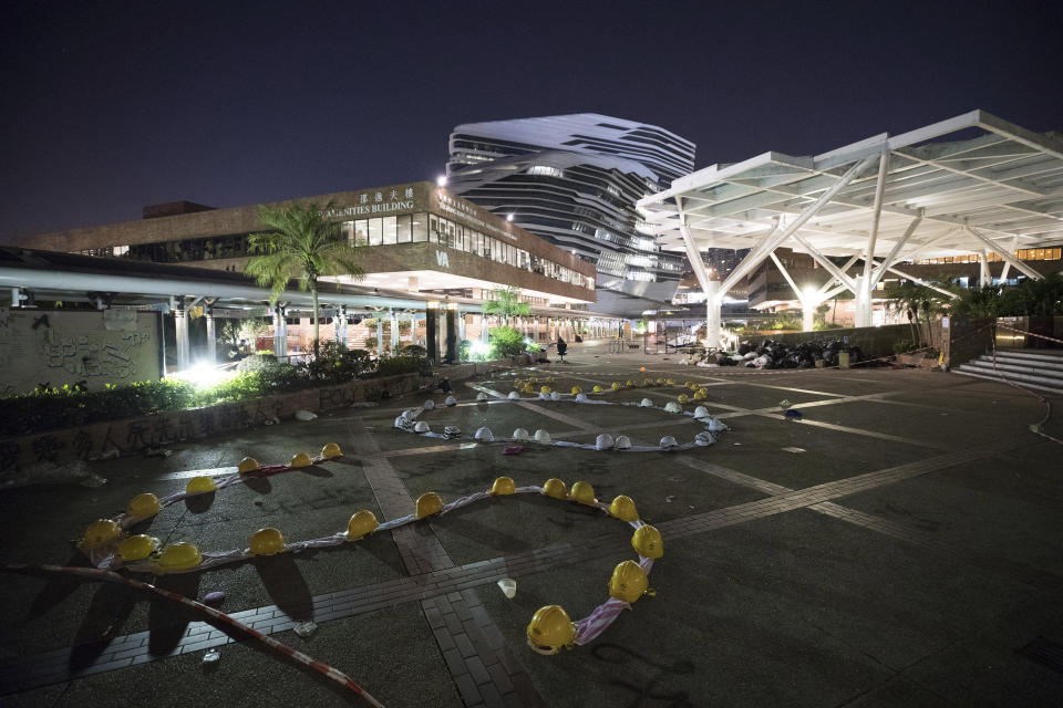 In this Friday, Nov. 22, 2019, photo, the message "SOS" is formed by protesters with clothes and helmets at the Hong Kong Polytechnic University campus in Hong Kong. Most of the protesters who took over the university have left following clashes with police, but an unknown number have remained inside, hoping somehow to avoid arrest. (AP Photo/Vincent Thian)