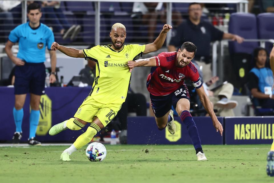 Aug 21, 2022; Nashville, Tennessee, USA;  Nashville SC midfielder Hany Mukhtar (10) plays for the ball against FC Dallas defender Matt Hedges (24) in the second half of the match at Geodis Park.