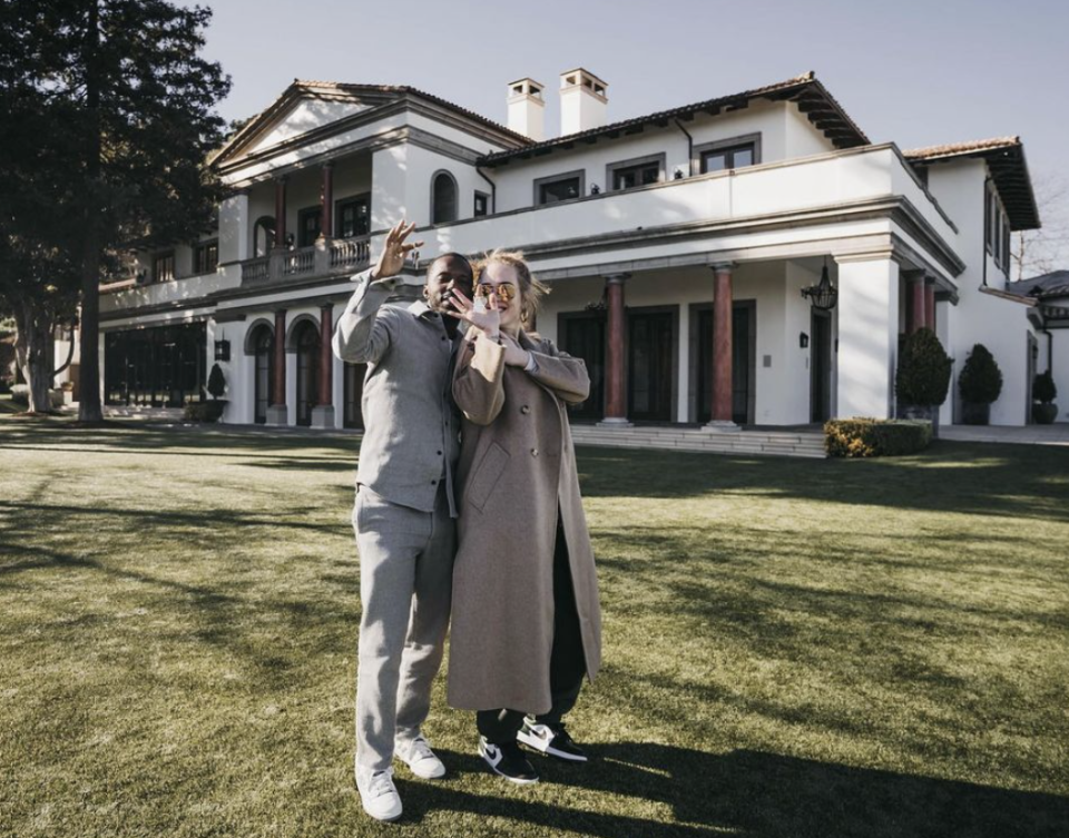 Rich Paul and Adele hold keys outside a mansion. 