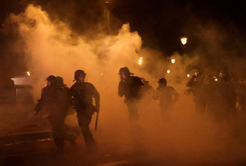 French CRS riot police run amid clashes with protesters during a demonstration as part of the ninth day of nationwide strikes and protests against French government's pension reform, in Paris, France, March 23, 2023.  REUTERS/Nacho Doce