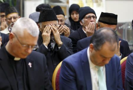 Father David Pennells of Mitcham Parish Church, attends a remembrance service for the victims of the recent attack in Westminster, at the Baitul Futuh Mosque, in south west London, Britain March 24, 2017. REUTERS/Peter Nicholls
