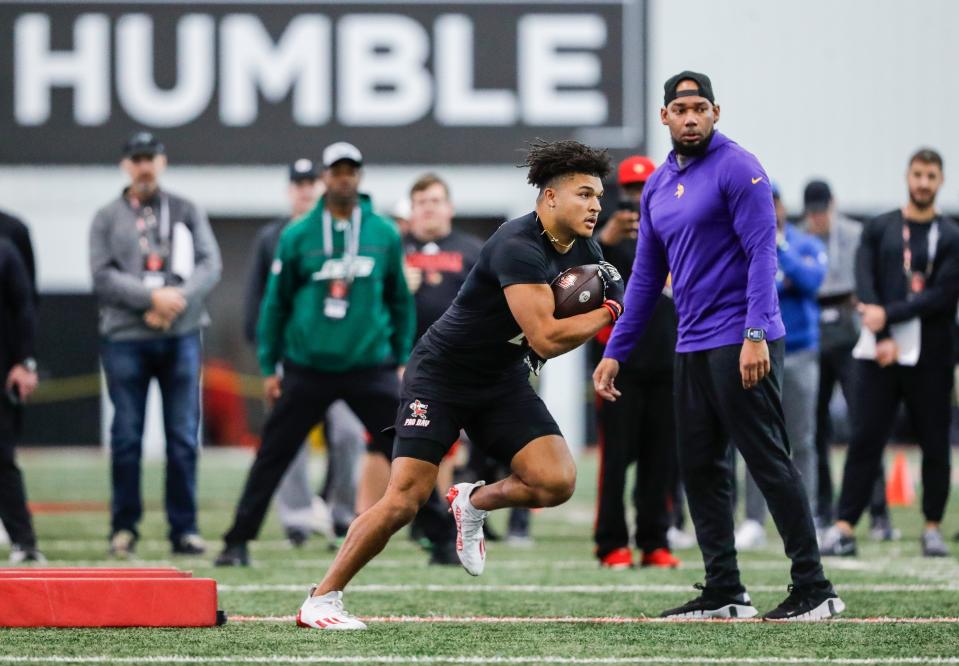 Louisville Cardinals senior running back Isaac Guerendo works out under the eyes of NFL scouts on Pro Day Tuesday morning. NFL scouts from several teams were evaluating Cardinal players. March 26, 2024