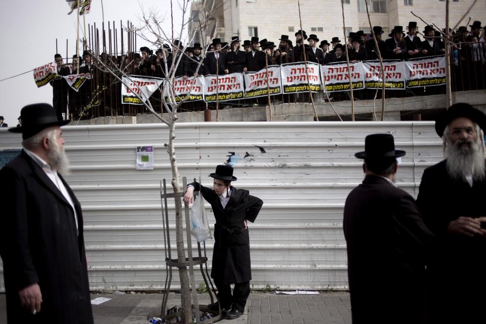 Ultra-Orthodox Jews gather for a rally in Jerusalem, Sunday, March 2, 2014. Israeli police closed the main highway into Jerusalem and the city’s central roads Sunday ahead of a mass rally by ultra-Orthodox Jews protesting government plans to draft them into the army. (AP Photo/Ariel Schalit)