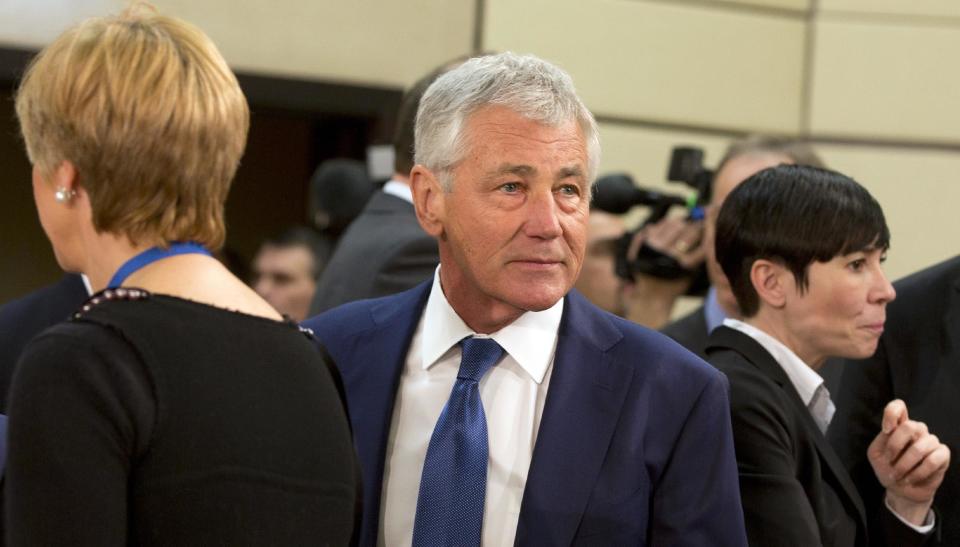 U.S. Secretary of Defense Chuck Hagel, center, arrives for a meeting of defense ministers of the North Atlantic Council at NATO headquarters in Brussels on Wednesday, Feb. 26, 2014. Frustrated with his Afghan counterpart, U.S. President Barack Obama is ordering the Pentagon to accelerate planning for a full U.S. troop withdrawal from Afghanistan by the end of this year. But Obama is also holding out hope that Afghanistan's next president may eventually sign a stalled security agreement that could prevent the U.S. from having to take that step. (AP Photo/Virginia Mayo)