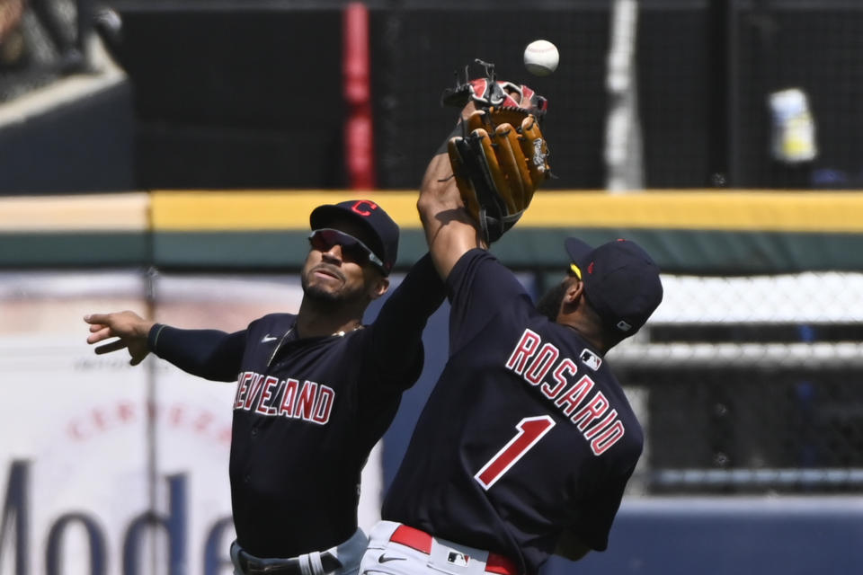 Cleveland Indians center fielder Oscar Mercado, left, and shortstop Amed Rosario (1) try and make a play on a ball hit by Chicago White Sox's Brian Goodwin during the fifth inning of a baseball game, Sunday, Aug. 1, 2021, in Chicago. (AP Photo/Matt Marton)