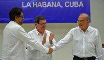 Colombian government delegation head Humberto de la Calle (R) and FARC-EP Commander Ivan Marquez (L) shake hands after signing a peace agreement at the Convention Palace in Havana, Cuba on August 24, 2016