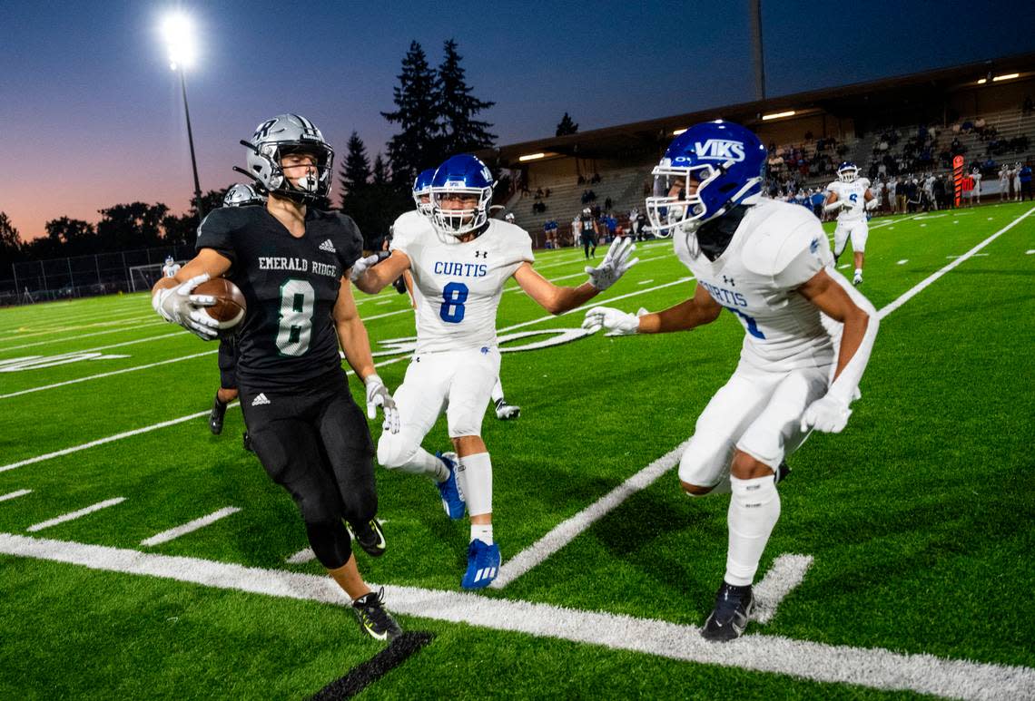 Emerald Ridge wide receiver Gio Kafentzis (8) runs out of bounds with the ball while Curtis defensive back Xavier Ahrens (8) and defends in the second quarter of a game at Sparks Stadium in Puyallup, Wash. on Sept. 22, 2022.