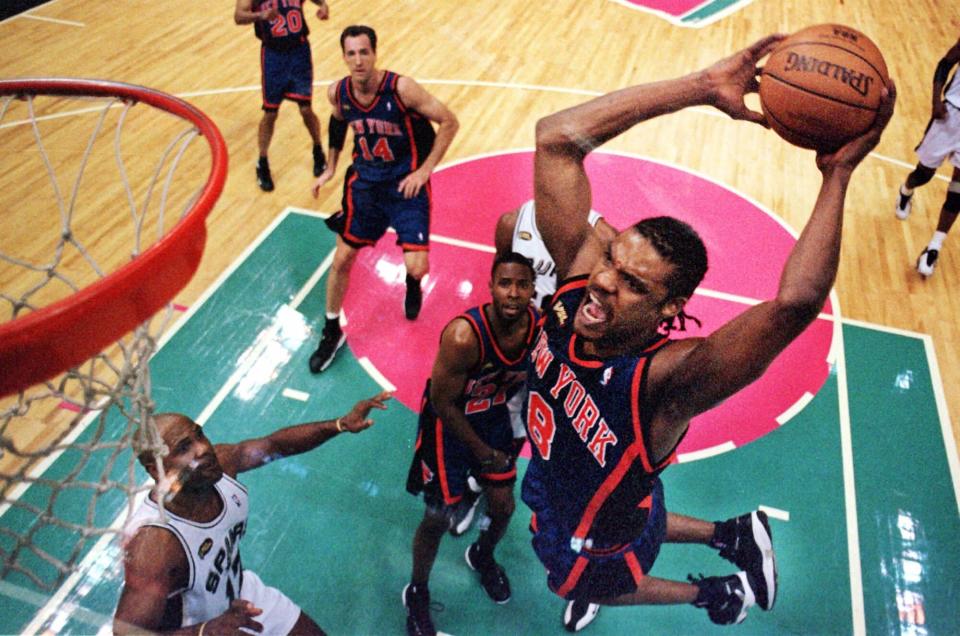New York Knicks guard Latrell Sprewell slams the ball through the net during first half action in Game 2 of the NBA finals in San Antonio, Texas, Friday, June 18, 1999.