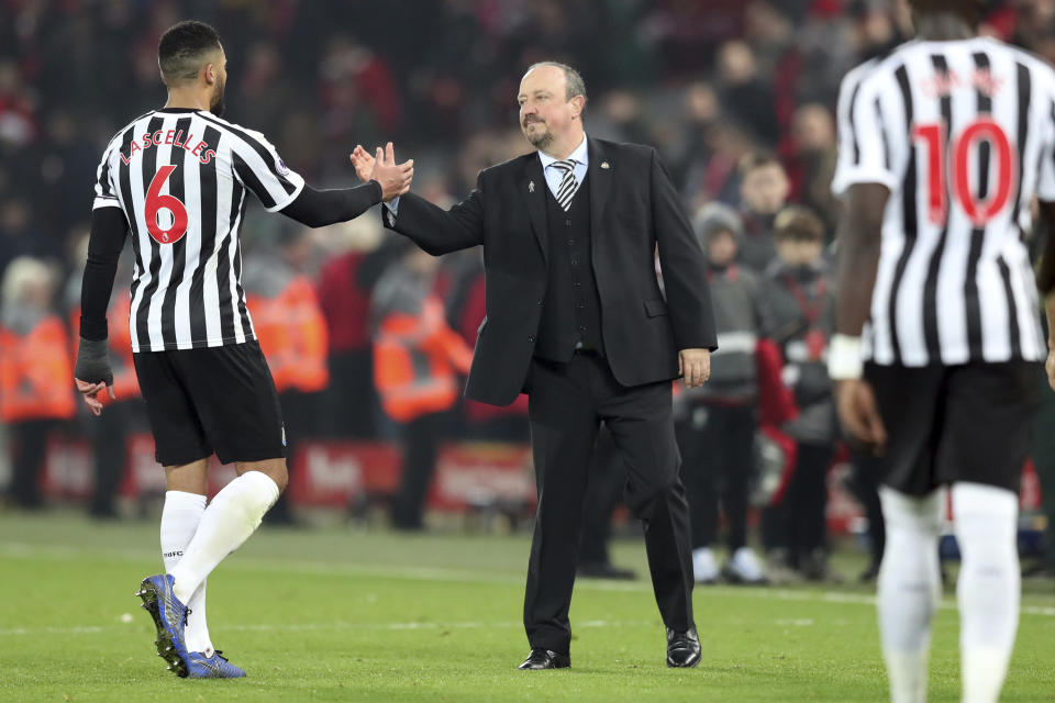 Newcastle coach Rafael Benitez, right, greets Newcastle's Mohamed Diame at the end of the English Premier League soccer match between Liverpool and Newcastle at Anfield Stadium, in Liverpool, England, Wednesday, Dec. 26, 2018. (AP Photo/Jon Super)
