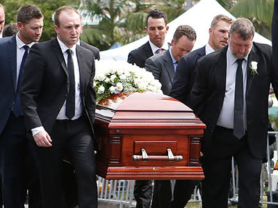 Phillip's coffin is carried away by his pallbearers.
