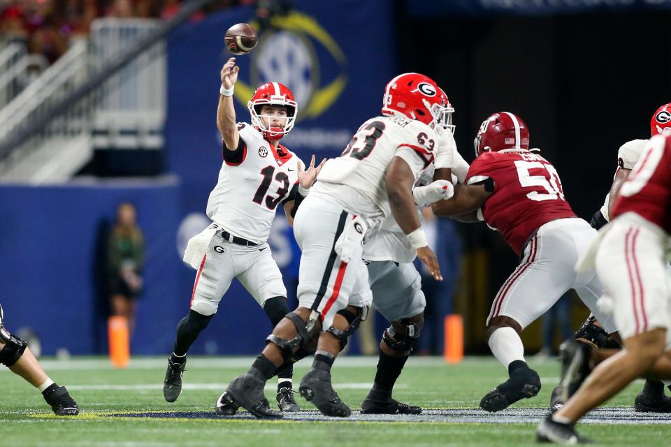 Georgia quarterback Stetson Bennett (13) throws against Alabama in the second half during the SEC championship game at Mercedes-Benz Stadium.