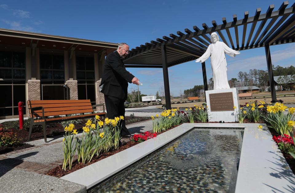 Fr. Joe Smith blesses the garden and reflecting pool at the St. Joseph's/Candler Richmond Hill campus on Friday.