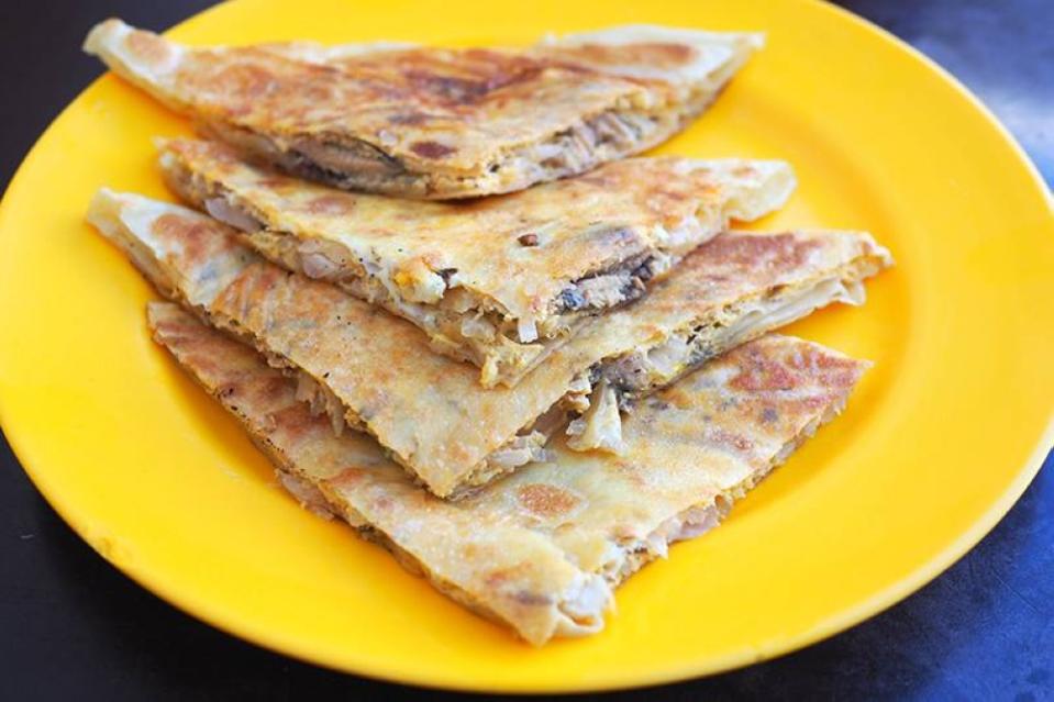 The 'roti sardin' looks like a crepe stuffed with onions, egg and canned sardines.