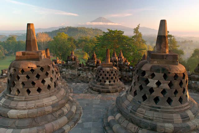 <p>Courtesy of Aman</p> The sun rises over the ninth-century Buddhist temple at Borobudur.