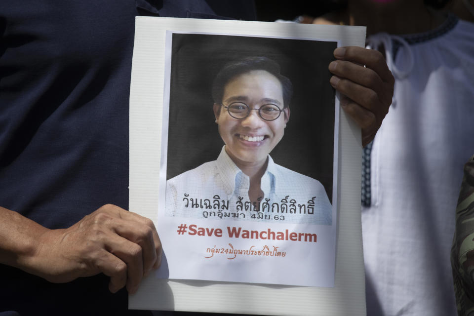 FILE - An activist holds a photo of Thai dissident Wanchalearm Satsaksit during a rally in front of Cambodian Embassy in Bangkok, Thailand, Monday, June 8, 2020. Wanchalearm, has been abducted in Phnom Penh, Cambodia, a human rights group said Friday, June 12, 2020 raising concern that a mysterious campaign targeting exiles for disappearance or death may have been revived. A leading international human rights organization on Thursday, May 16, 2024, criticized the Thai government for helping its authoritarian neighbors by expelling political dissidents who fled to Thailand for safety and forcing them to return to their home countries. (AP Photo/Sakchai Lalit), File)
