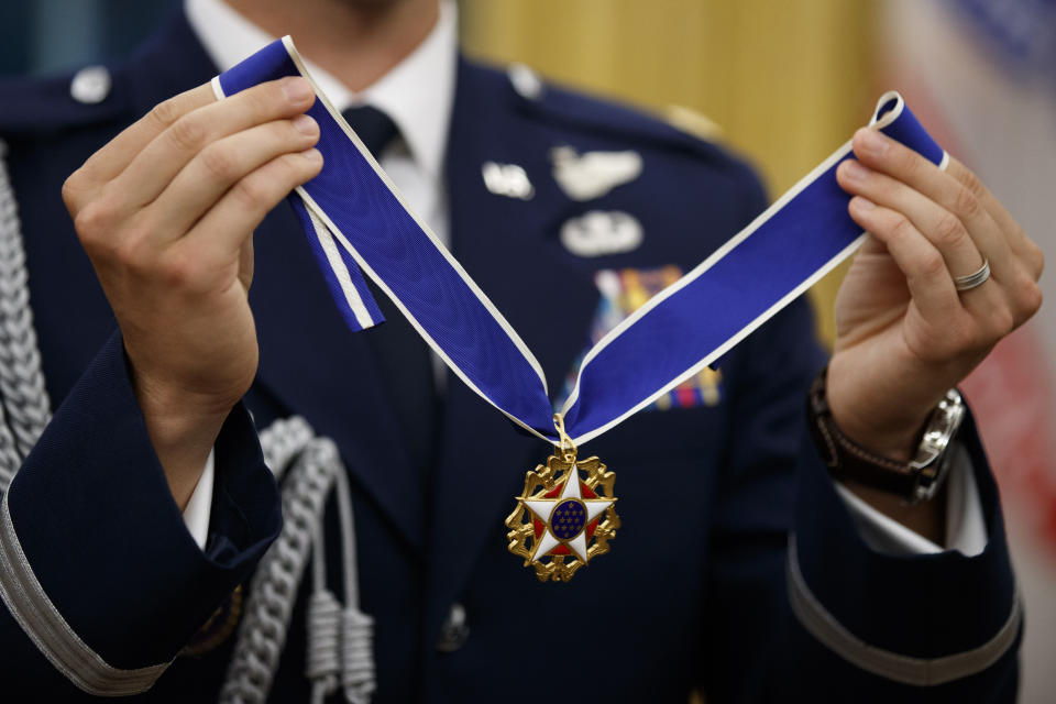 A U.S. Air Force military aide holds the Presidential Medal of Freedom to be presented to former NBA basketball player and general manager Jerry West by President Donald Trump, in the Oval Office of the White House, Thursday, Sept. 5, 2019, in Washington. (AP Photo/Alex Brandon)