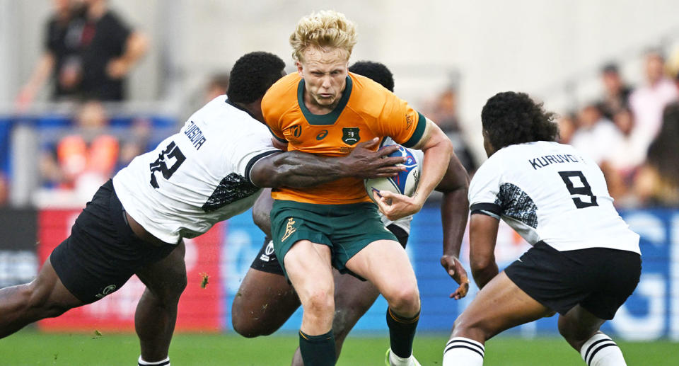 Seen here, Aussie fly-half Carter Gordon being tackled by Fijian players.