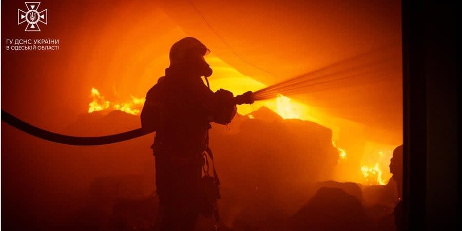 A rescuer puts out a fire after the strike of the Russian Federation