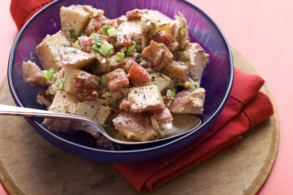 In this image taken on June 3, 2013, three-pepper barbecue potato salad is shown served in a bowl in Concord, N.H. (AP Photo/Matthew Mead)