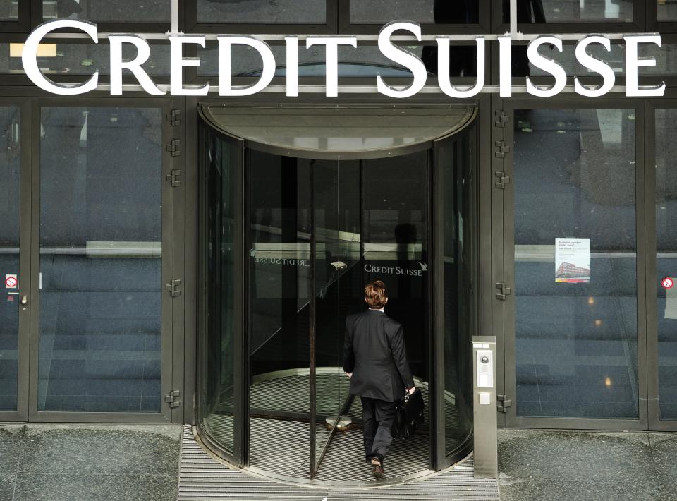 FILE - In this May 12, 2010 file picture a man enters a Credit Suisse bank in Zurich, Switzerland. The bank reported Thursday, Feb. 6, 2014 a net profit of 267 million francs (US dollar 295 million) for the October-December period, compared with 263 million francs a year earlier. The flat performance came as the company set aside 339 million francs to deal with ongoing mortgage litigation — pushing its investment bank unit to a pretax loss — and made a further provision of 175 million francs for costs related to a U.S. investigation of alleged tax evasion. (AP Photo/Keystone/Steffen Schmidt,File)