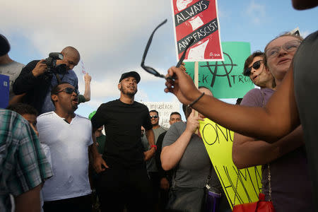 Demonstrators face off with counter-protesters during an America First rally in Laguna Beach, California, U.S., August 20, 2017. REUTERS/Sandy Huffaker