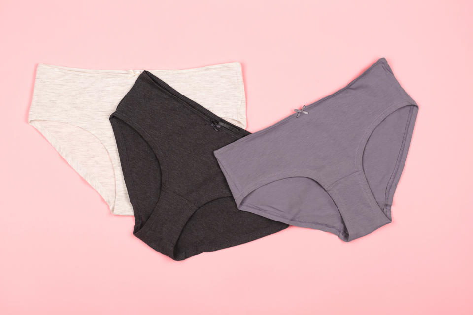 Woman panties on the pastel pink background. Flat-lay, top view.