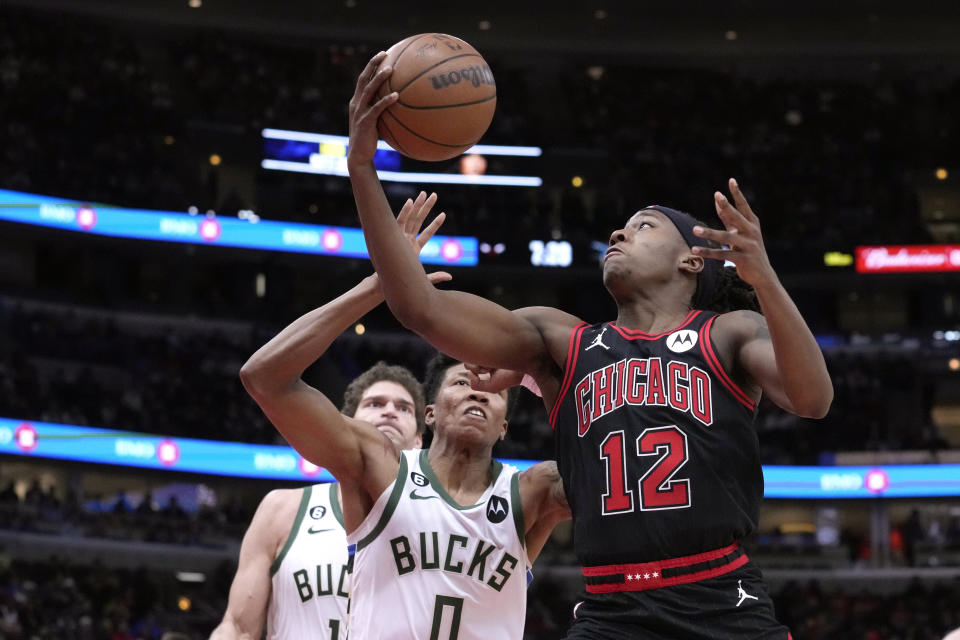 Chicago Bulls' Ayo Dosunmu (12) drives to the basket as Milwaukee Bucks' MarJon Beauchamp defends during the first half of an NBA basketball game Thursday, Feb. 16, 2023, in Chicago. (AP Photo/Charles Rex Arbogast)