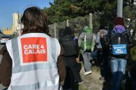 Charity workers with the "Care 4 Calais" charity escort young migrants to a reception centre in Calais, northern France on October 28, 2016