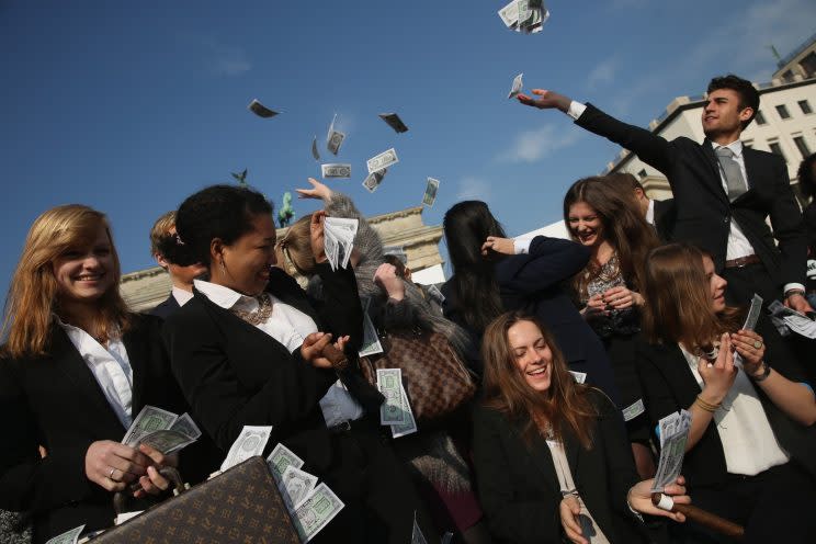 BERLIN, GERMANY - APRIL 13: Activists wearing suits throw fake money into the air while demanding greater trasparency in new legislation following the ongoing Panama Papers affair on April 13, 2016 in Berlin, Germany. Police in Panama have reportedly raided the offices of Mossack Fonseca, the law-firm accused of facilitating large-scale offshore tax evasion for thousands of its clients. (Photo by Sean Gallup/Getty Images)