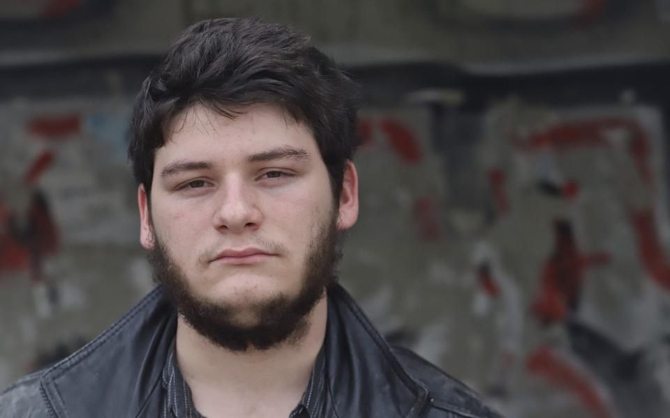 Naveh Shabtay, 19, a refusenik or an Israeli military draft evader for political reasons, is seen moments before entering the recruiting military base in Tel Aviv - Quique Kierszenbaum