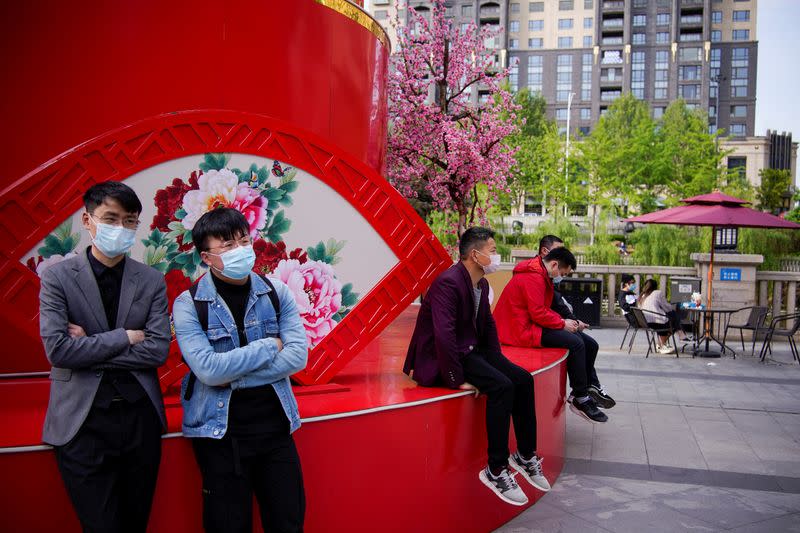 People wearing face masks are seen at a main shopping area after the lockdown was lifted in Wuhan