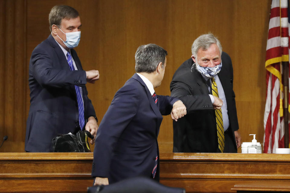 Rep. John Ratcliffe, R-Texas, center, arrives to a Senate Intelligence Committee nomination hearing on Capitol Hill in Washington, Tuesday, May. 5, 2020 and is greeted by committee Chairman Sen. Richard Burr, R-N.C. and Vice Chairman Sen. Mark Warner, D-Va., left. The panel is considering Ratcliffe's nomination for director of national intelligence. (AP Photo/Andrew Harnik, Pool)