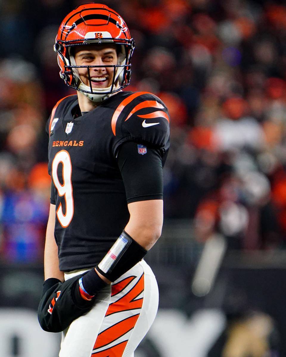 Cincinnati Bengals quarterback Joe Burrow (9) smiles during a timeout in the fourth quarter during an NFL AFC wild-card playoff game against the Las Vegas Raiders, Saturday, Jan. 15, 2022, at Paul Brown Stadium in Cincinnati. The Cincinnati Bengals defeated the Las Vegas Raiders, 26-19. to win the franchise's first playoff game in 30 years.