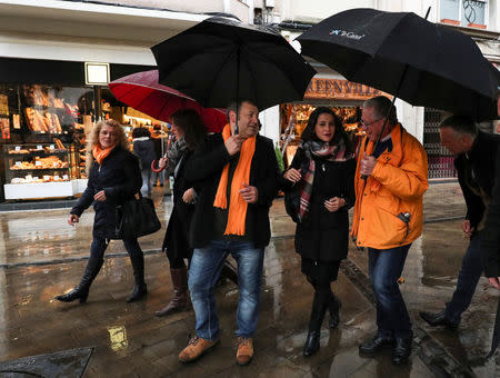 Ciudiadanos party leader in Catalonia, Ines Arrimadas (C), walks under umbrellas during a campaign stop in Figueres, Spain, December 15, 2017. REUTERS/Albert Gea