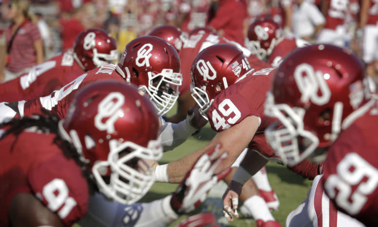 Oklahoma's linemen warming up before a football game against the West Virginia Mountaineers.