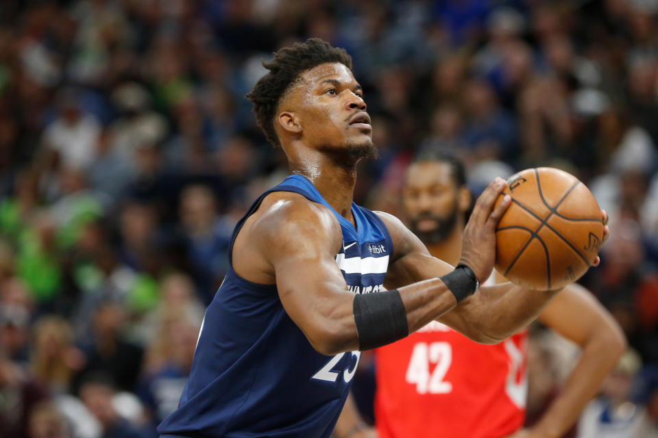 FILE - In this April 21, 2018, file photo, Minnesota Timberwolves' Jimmy Butler plays against the Houston Rockets in the first half during Game 3 of an NBA basketball first round playoff series in Minneapolis. With Butler's trade demand swirling like a dark cloud around coach Tom Thibodeau, newly minted super-max player Karl-Anthony Towns and the Timberwolves arrive for training camp. (AP Photo/Jim Mone, File)