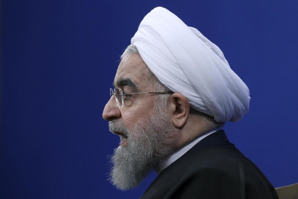 Iranian President Hassan Rouhani speaks in a press conference at the presidency compound in Tehran, Iran, Tuesday, Jan. 17, 2017. Iran's president has compared talk of renegotiating its nuclear accord to "converting a shirt back to cotton," and says U.S. President-elect Donald Trump's talk of doing so is "mainly slogans." (AP Photo/Vahid Salemi)