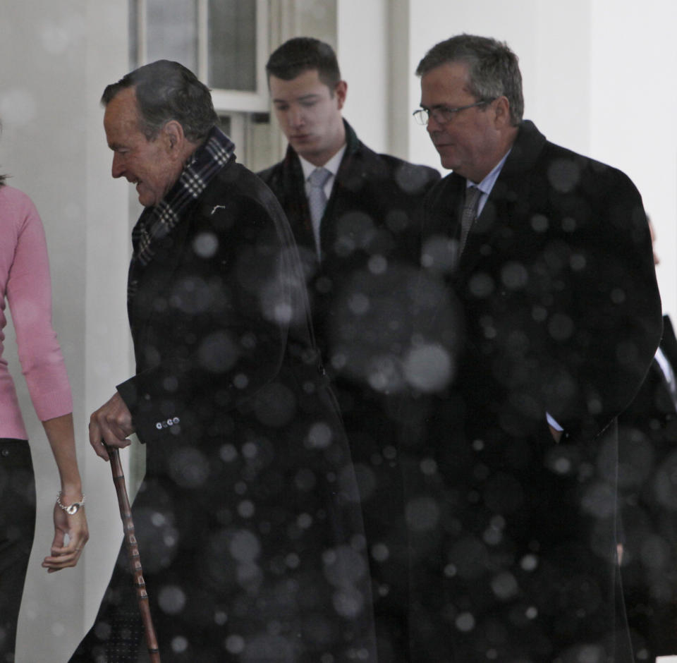President George H. W. Bush -- with his son, former Florida Gov. Jeb Bush -- enters the West Wing of the White House to meet with President Barack Obama on Saturday, Jan. 30, 2010, in Washington.  (AP Photo/Alex Brandon)