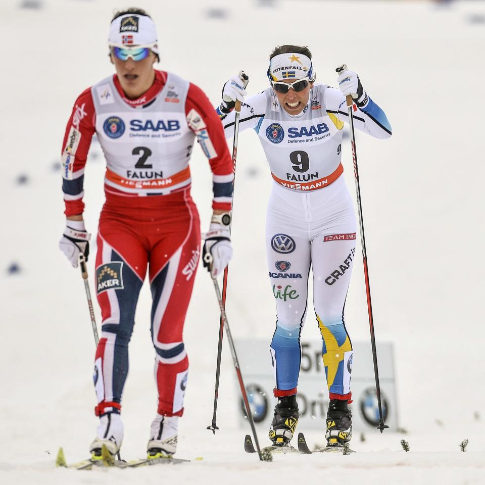 Norway's Marit Bjoergen, left, first place and Charlotte Kalla of Sweden second place after the quarter final Woman's FIS Cross-Country World Cup 1,2 km Sprint Classic in Falun,Sweden, Friday March 14, 2014. (AP Photo/TT, Anders Wiklund) SWEDEN OUT
