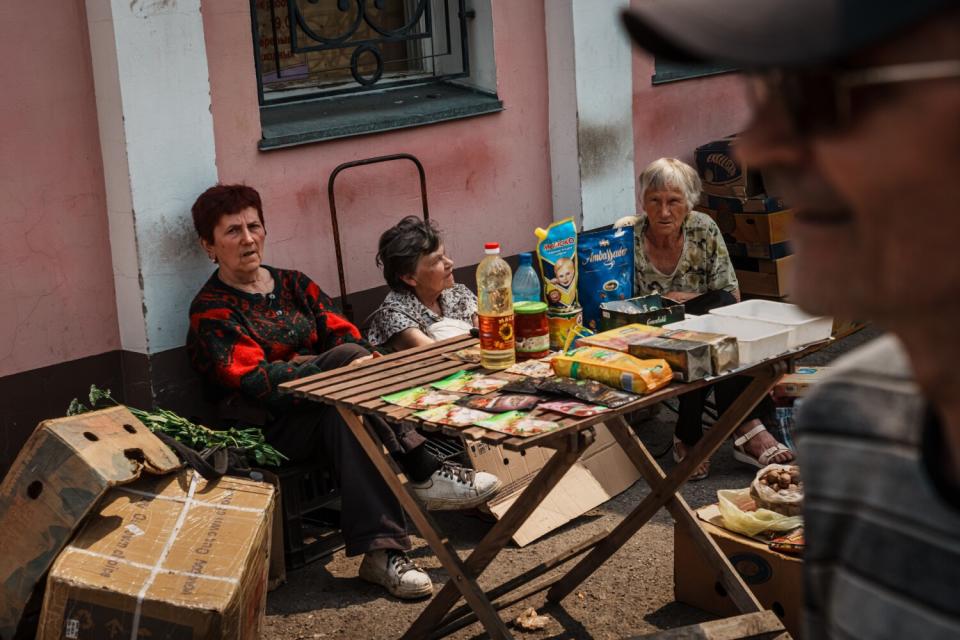 Residents sell their wares at a day time street market in Lysychansk, Ukraine.