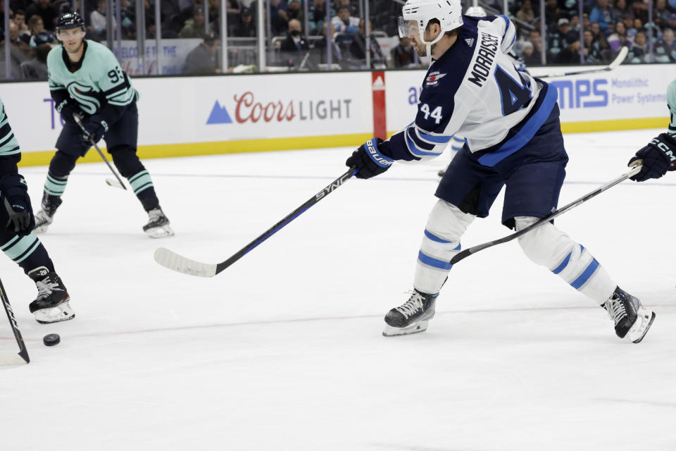 Winnipeg Jets defenseman Josh Morrissey (44) shoots the winning goal against the Seattle Kraken during overtime period of an NHL hockey game, Sunday, Nov. 13, 2022, in Seattle. (AP Photo/John Froschauer)