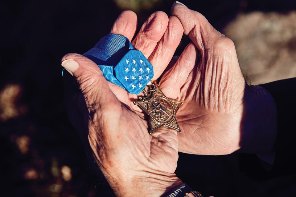 Hershel “Woody” Williams holding his Medal of Honor