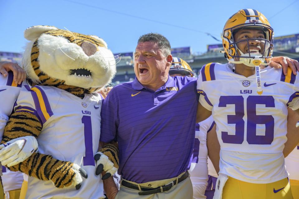 LSU coach Ed Orgeron celebrates his team's 49-42 victory against Florida