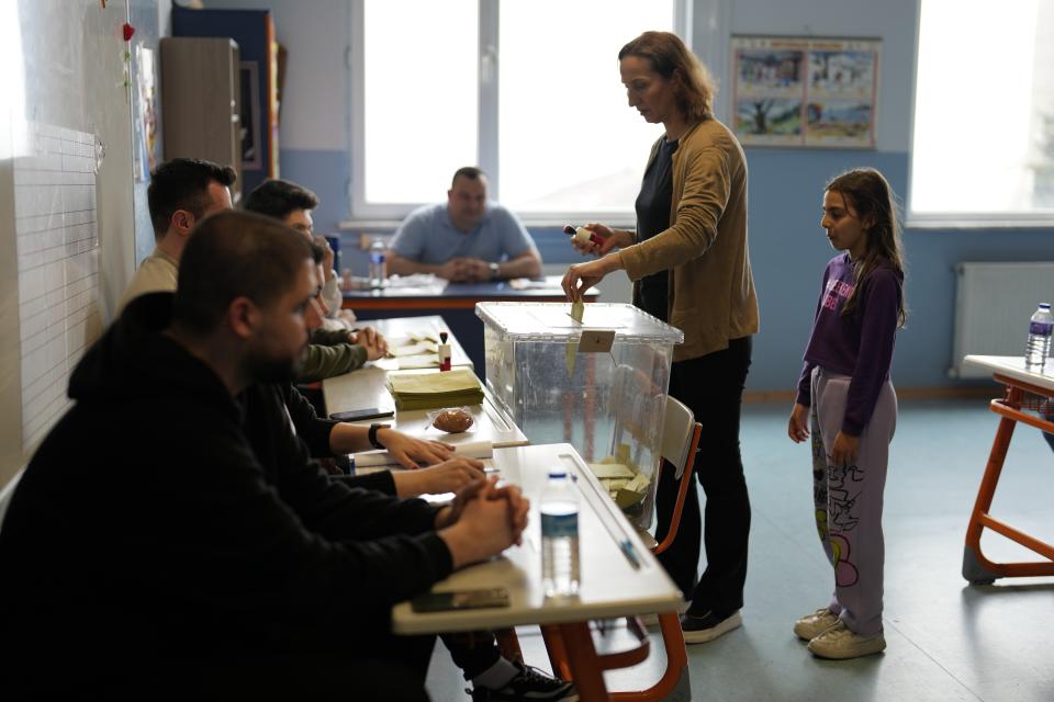 FILE - A woman casts her ballot at a polling station in Istanbul, Turkey, Sunday, May 28, 2023. Recep Tayyip Erdogan, 69, takes the oath of office Saturday and starts his third presidential term after scoring another electoral victory last month. Already the longest-serving leader in the republic's history, Erdogan will now be stretching his rule into a third decade - until 2028 – and possibly even longer with the help of a friendly parliament. (AP Photo/Khalil Hamra, File)